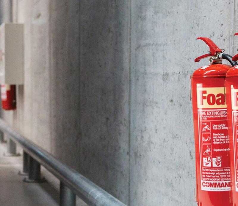 Fire extinguisher location sign on a wall, guiding people to safety equipment in a building